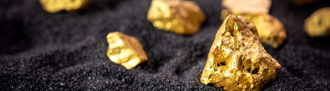 Multiple Gold nuggets set against a black background.