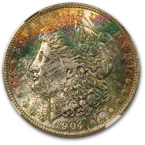 1904-O Morgan Dollar MS-65 NGC (Black & Rainbow Toning) 1904-O Morgan Dollar MS-65 NGC (Black & Rainbow Toning)